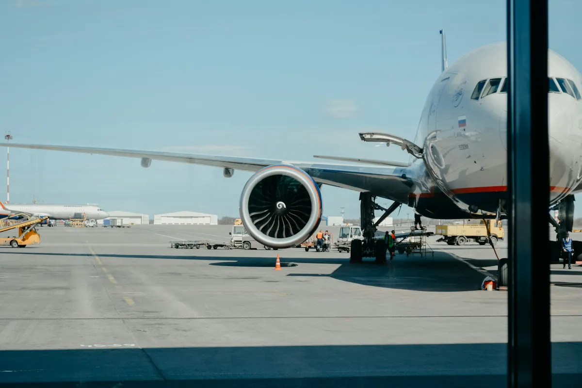 The left-hand side of an airplane sitting at the gate