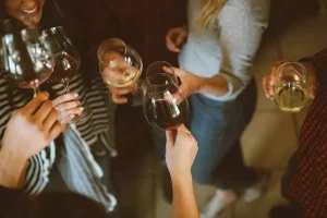 A group of women standing with wine glasses on a night out